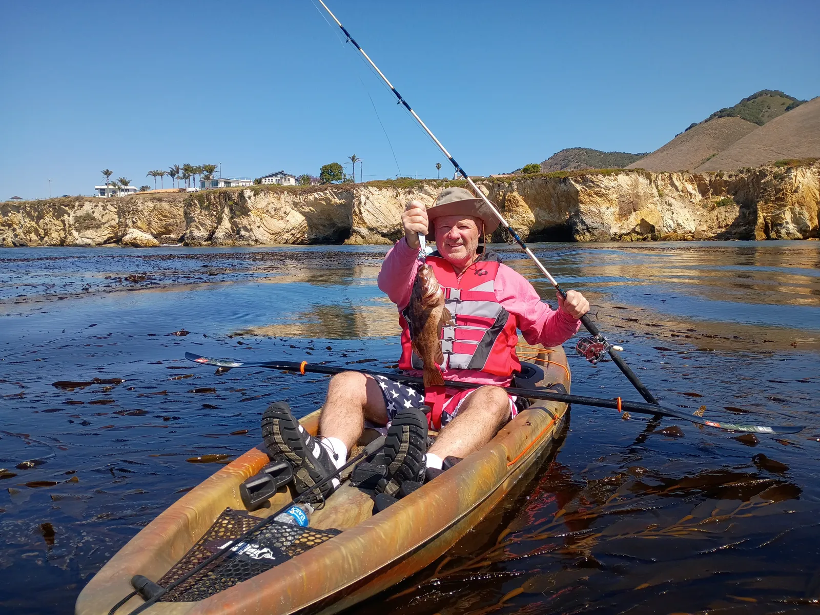 Angler with a fresh rockfish on a kayak fishing tour